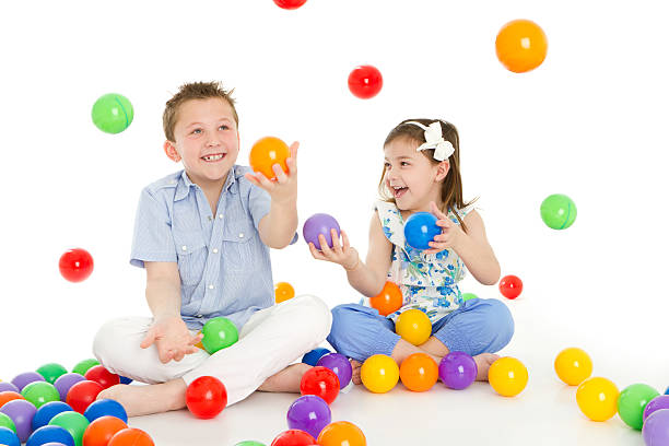 Siblings playing with colorful balls Sibling's relationship 9 stock pictures, royalty-free photos & images