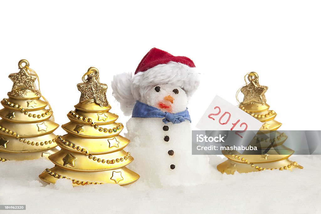 Little snowman. Little snowman with Golden fur-trees in a snowdrift. 2012 Stock Photo