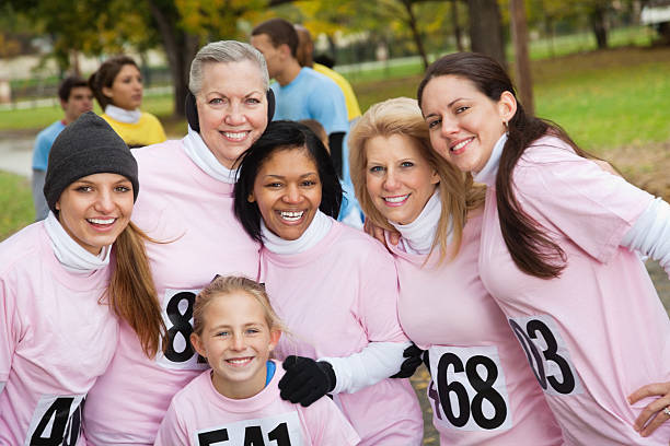 istock Diverse team in pink posing at a charity race event 184962542