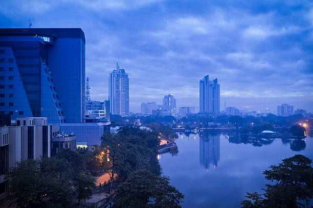 Blue Skyline of Colombo "Skyline of Colombo (the capital of sri lanka) to dawn - Beira Lake is a lake in the heart of the city of Colombo, Sri Lanka. The lake is surrounded by many important businesses in the city. It occupied approximately 165 hectares of land 100 years ago and has been reduced to mere 65 hectares today due to various reasons." sri lanka skyline stock pictures, royalty-free photos & images