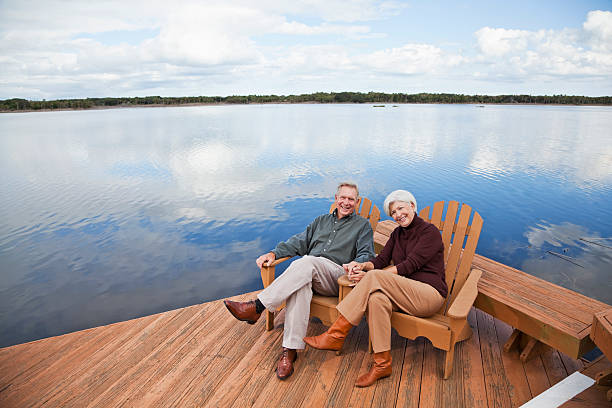 istock Senior couple sitting by water 184963380