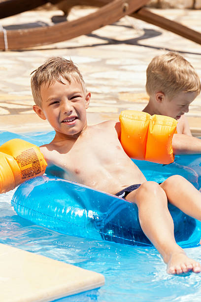 istock Two little boys having fun in the swimming pool 184963435