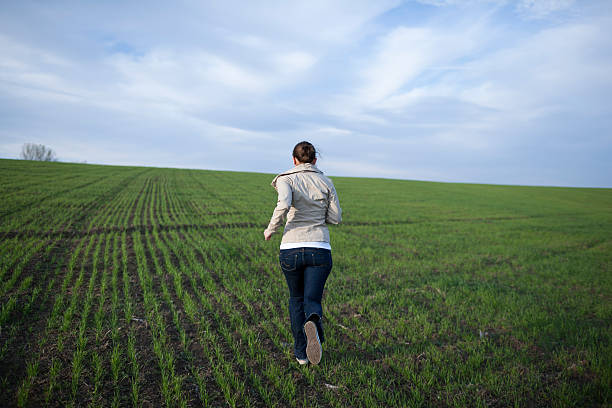 istock girl running on a field 184963634