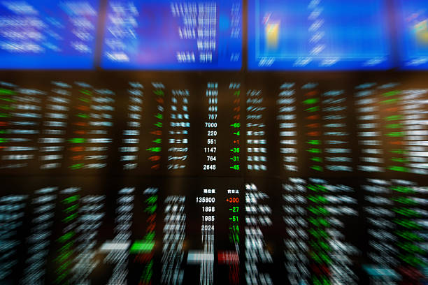 Stock Exchange Charts Zoom-out blur of stock chart billboard of stock exchange in asian language. Selective focus on the center stock price quotes. nikkei index stock pictures, royalty-free photos & images