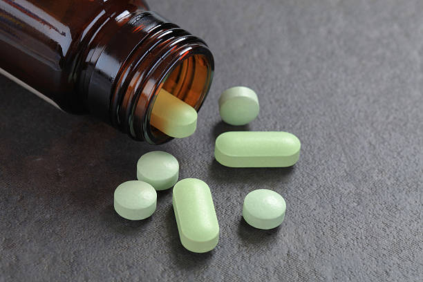 istock Pills pouring out of bottle 184964025