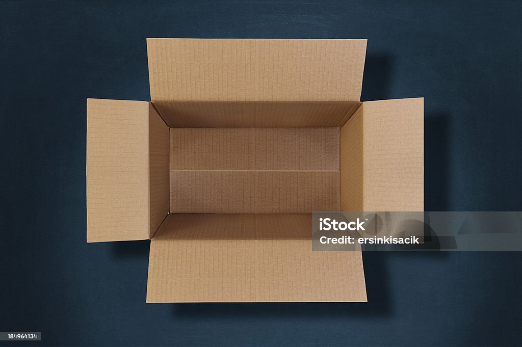 top view of an empty cardboard box Empty cardboard box on blue velvet background. Cardboard Box Stock Photo