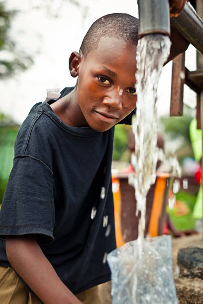 istock African Boy By Water Pump 184964338