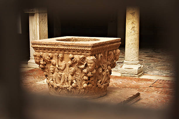 Old well with high relief in a Venice courtyard seen from the gate