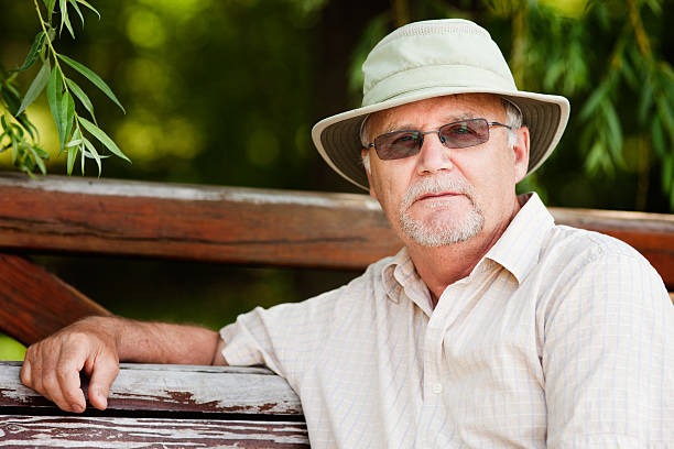istock Senior Man with Summer hat sitting in the shade 184964739