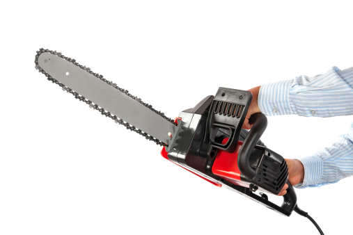 Manual worker with electric chainsaw isolated on white