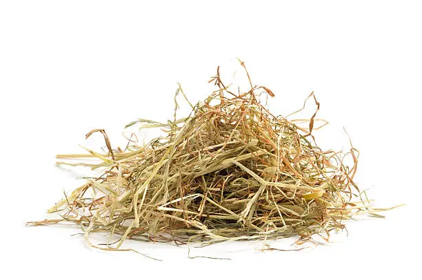"Small pile of hay, isolated on awhite background."