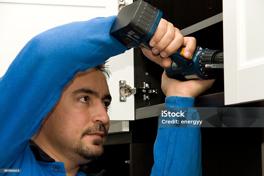 Mounting furniture with screwdriver Closet Stock Photo