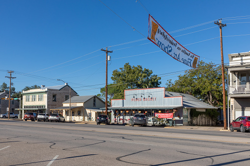 Fredericksburg, USA - November 1, 2023: The Main Street in Fredericksburg, Texas, also known as The Magic Mile, with retail stores and people walking.