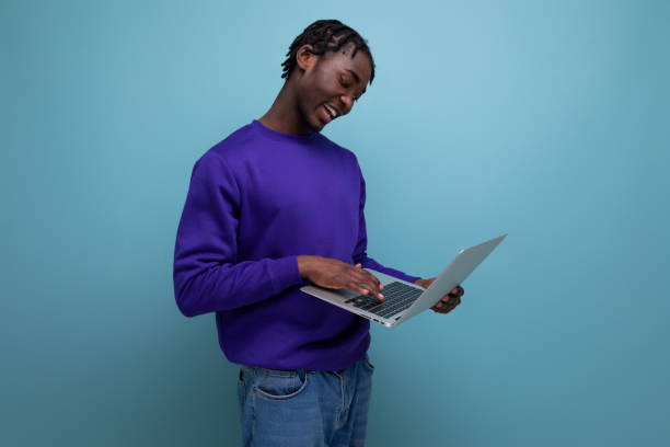 istock office specialist african young brunette man with dreadlocks with laptop 1849657527