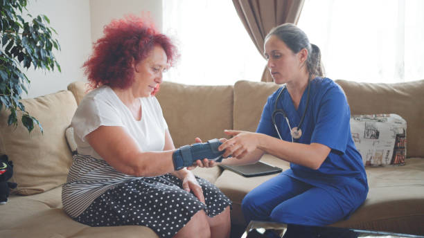 istock Female GP doing home visit. Home caregiver. 1849660496