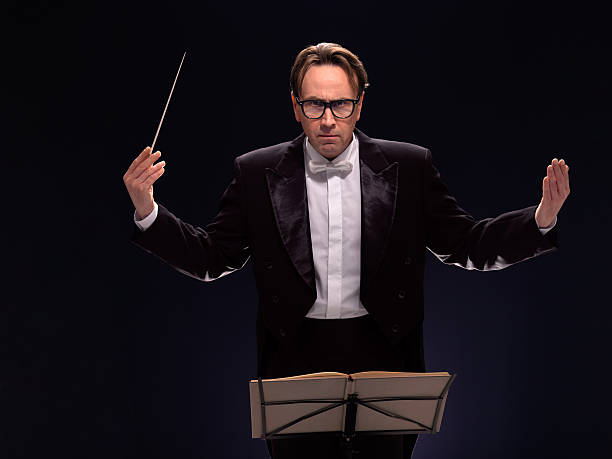 conductor Series of middle age conductor isolated on dark background tail coat photos stock pictures, royalty-free photos & images