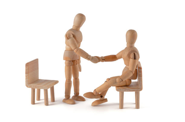 istock Shaking hands - wooden mannequin meeting 184966782