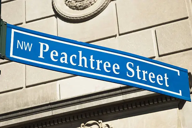 "Angled view of a Peachtree street sign in Atlanta.  Peachtree street is the most prominent street in Atlanta, that ties the Downtown, Midtown, and Buckhead business districts together."