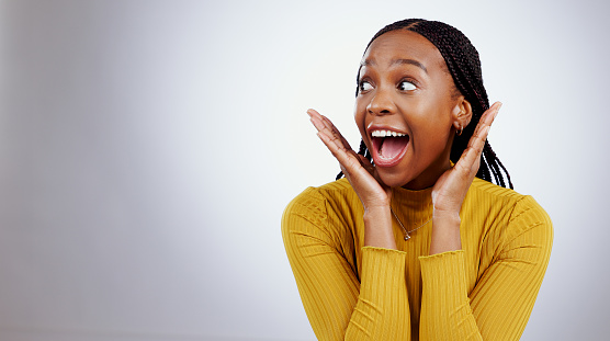 Surprise, wow and black woman with mockup in studio for announcement, news or promo on grey background. Omg, emoji and excited African female model with secret, deal or prize giveaway, lotto or info