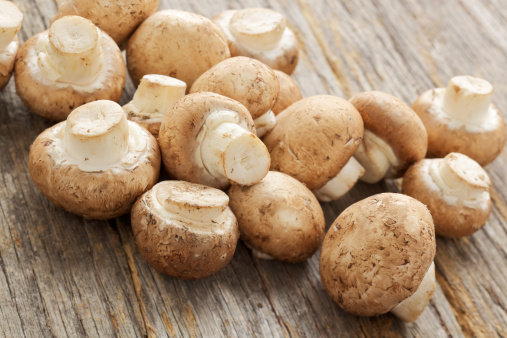 Natural light photo of fresh organic white mushrooms on rustic wood tablePlease view more rustic food images here: