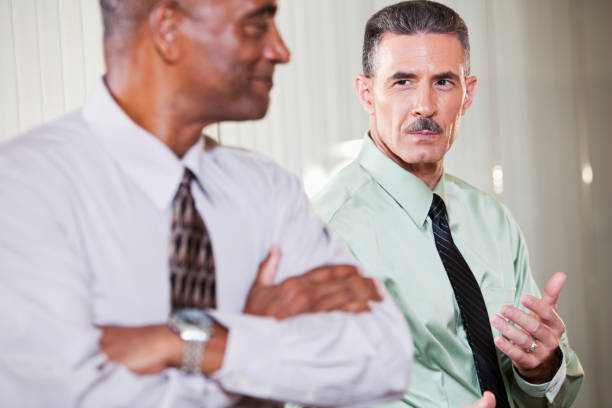 istock Serious businessman with smiling colleague 184968354
