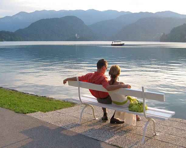 istock Couple in love sitting by the lake 184968517