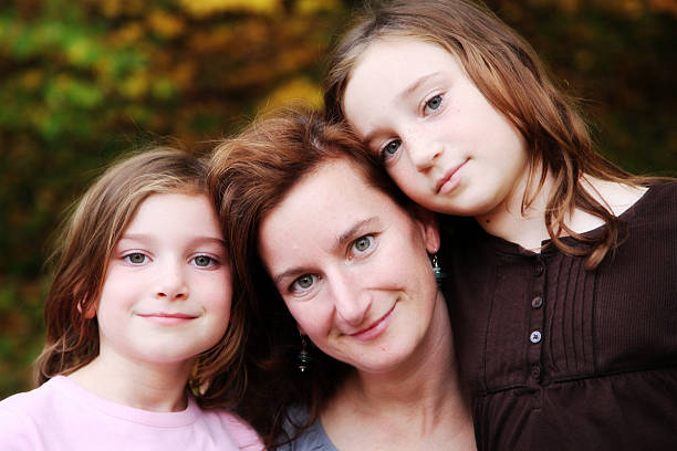 istock Beautiful Mother and Daughters Looking at Camera 184968572