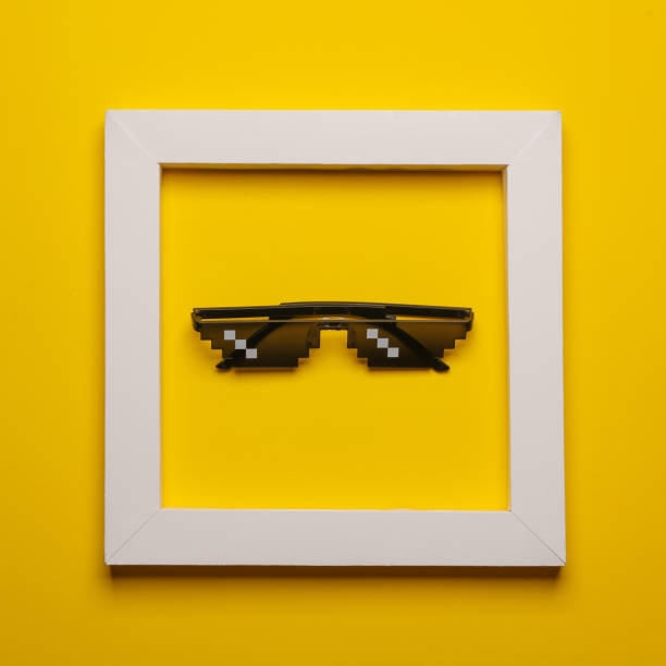 istock 8 bit pixel sunglasse in white frame on yellow background. Creative fashion layout. Minimalism 1849688003