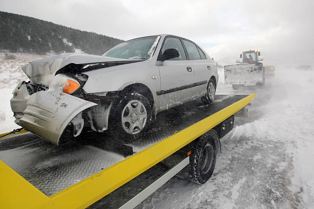 Damages car on the back of a truck after accident stock photo