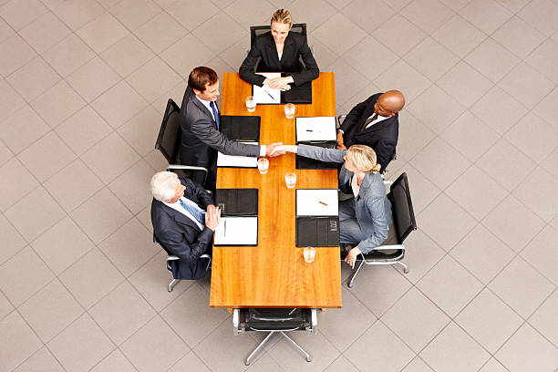 istock Business People Shaking Hands Over a Conference Table 184969044