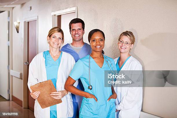 Medical Workers Standing In Hospital Corridor Stock Photo - Download Image Now - 40-49 Years, Cheerful, Doctor