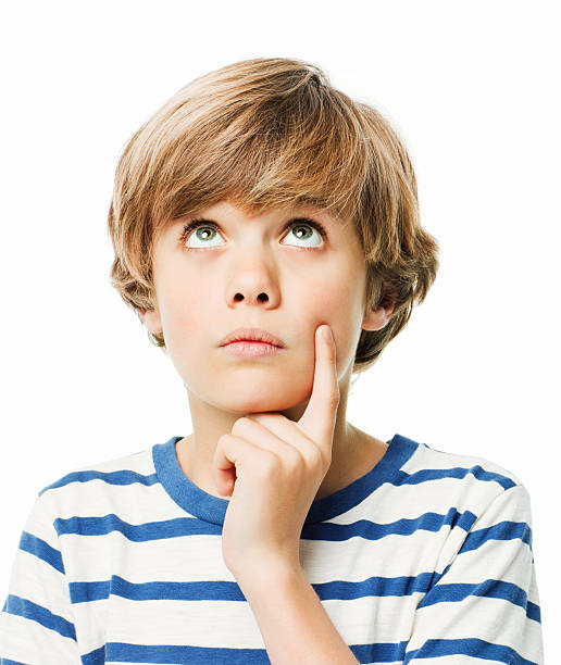 istock Young Boy Looking Up in Contemplation - Isolated 184969229