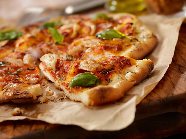 Marinara Pizza Authentic Italian, Hand Made Marinara Pizza with Roasted Garlic, Marinara Sauce, Fresh Basil and Olive Oil- Photographed on a Hasselblad H3D11-39 megapixel Camera System flatbread stock pictures, royalty-free photos & images