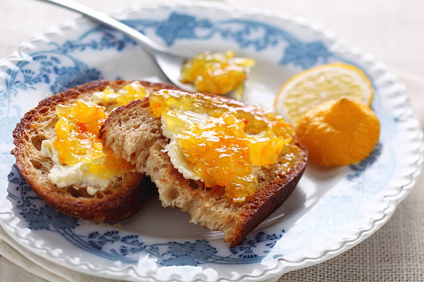 Bread with marmalade Morning toasts with butter and citrus marmalade marmalade stock pictures, royalty-free photos & images
