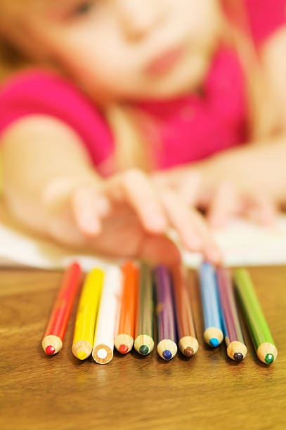 istock Girl Reaching for Pencils 184969733