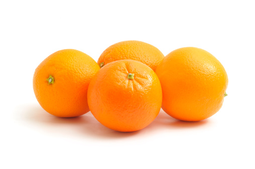 Four oranges isolated on a white background.
