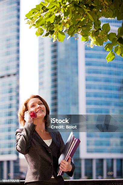 Smiling Businesswoman Talking On Mobile Phone Outdoors Stock Photo - Download Image Now