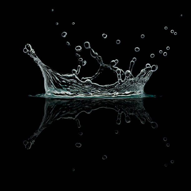 Splash isolated on black dark field photo of a splash of water isolated on black water on black surface stock pictures, royalty-free photos & images