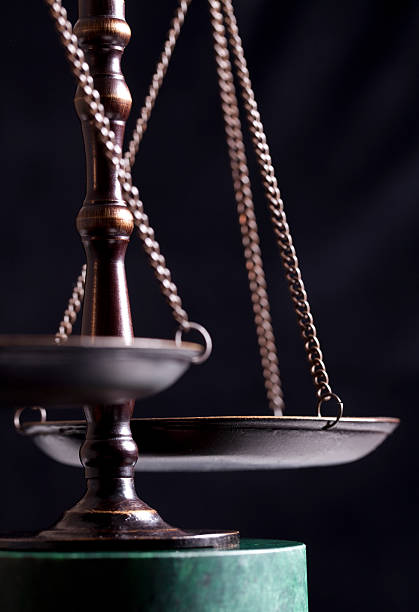 Scales of justice on black background