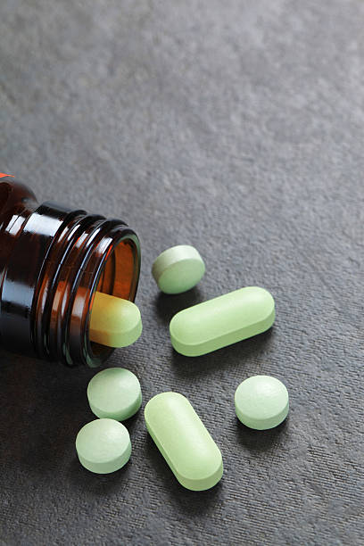 istock Pills pouring out of bottles 184971073