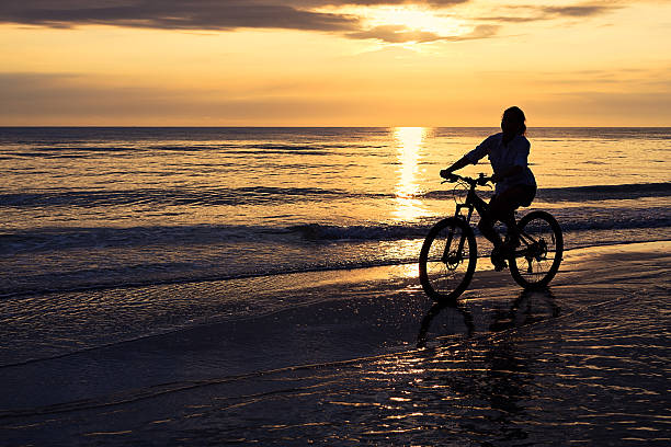 istock Woman with bicycle at beach 184971745