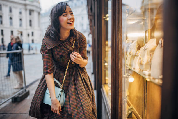 Woman window shopping Modern young woman window shopping for jewelry in Vienna. city street consumerism window display vienna stock pictures, royalty-free photos & images