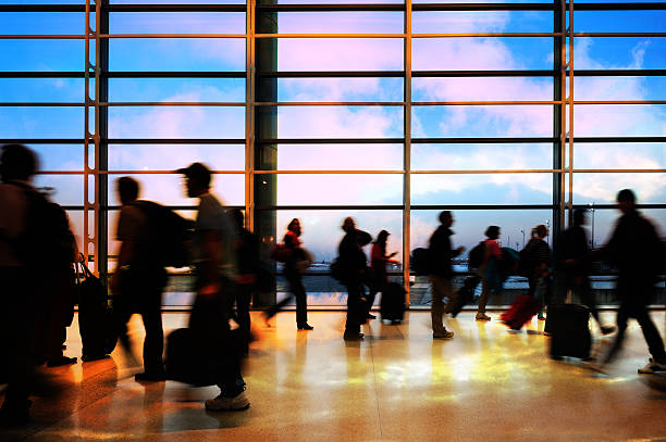 istock Modern airport terminal, travellers in silhouette 184973173