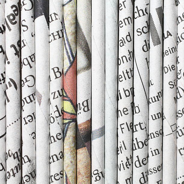 rolled newspaper pages stock photo