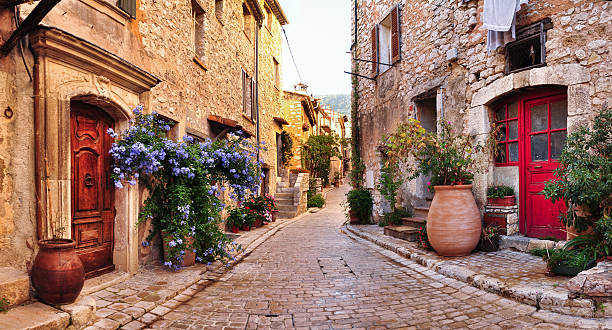 Old French village houses and cobblestone street "Old, romantic, french stone street panorama,very romantic and typical for Nice city region" narrow stock pictures, royalty-free photos & images