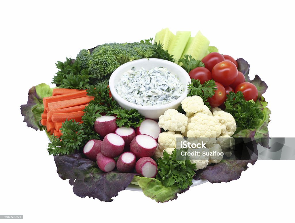 crudite platter "A plate of fresh vegetables on red bibb lettuce, with a bowl of creamy spinach onion dip. Includes broccoli, cauliflower, radishes, carrots, cherry tomatoes, and cucumbers, and garnished with curly parsley. Isolated on white." Vegetable Stock Photo