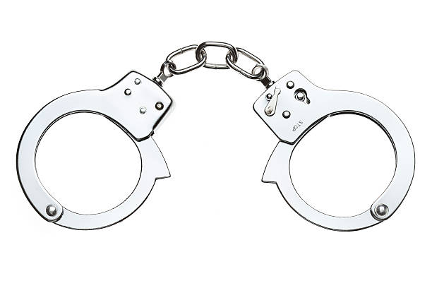 Handcuffs - Isolated on White "Close-up shot of handcuffs, isolated on white. Perfect isolation achieved in camera. (5D Mark II, Adobe RGB)Other photos from the series:" handcuffs stock pictures, royalty-free photos & images