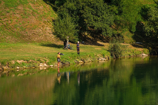 Srpske Toplice, Bosnia - September 5th 2023. Men fish in the Vrbas River as it flows through Srpske Toplice south east of Banja Luka in Republika Srpska, Bosnia and Herzegovina. Viewed at Vrucica Hot Springs