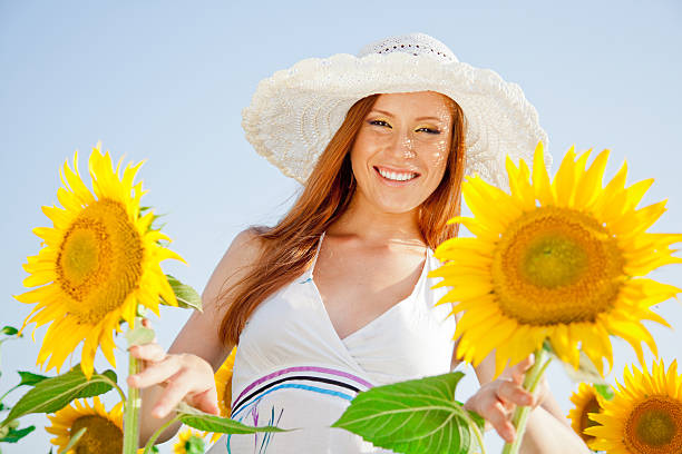 Photo of Sunny, full of life, young woman portrait with sunflowers