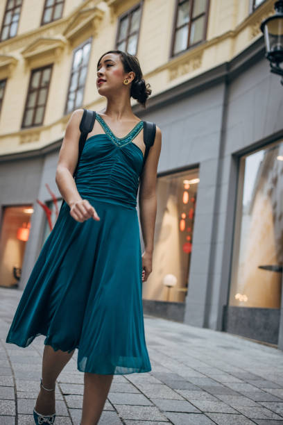 Young woman musician with violin case walking the streets in Vienna.
